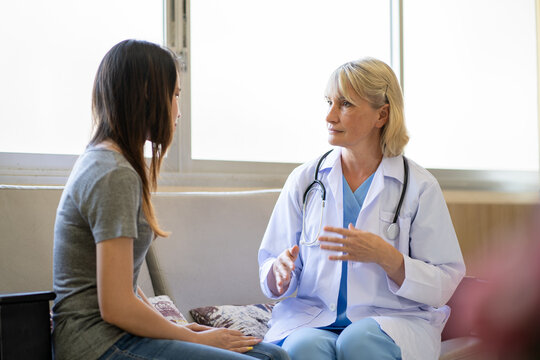 Professional psychiatrist listening to her patient in medical clinic or hospital mental health service