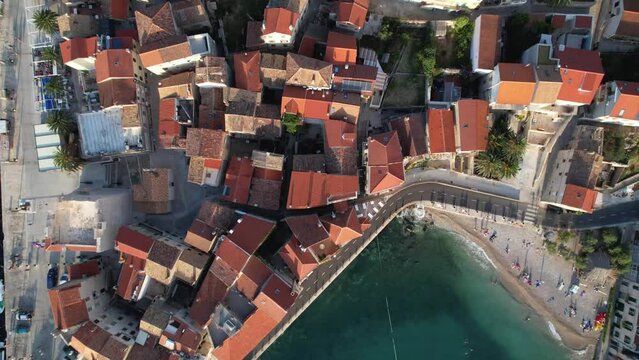Top Down Aerial Pass Over Red Roof Town of Komiza During Golden Hour in Vis Island Croatia Magical Beautiful Croatian Coastal Village Adriatic Sea Drone 4K