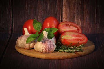 fresh vegetables on wooden board. Tomato, Basil, Garlic, Rosemary