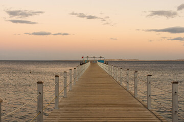 Wooden pontoon at sea, Golden sea sunset.