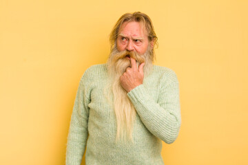 senior cool bearded man with surprised, nervous, worried or frightened look, looking to the side...