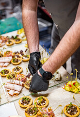 Chef hand is in process of Preparing catering food on table
