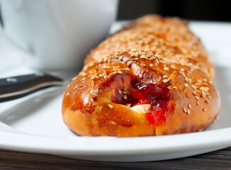 Sweet bread stuffed with strawberry jam and cheese, with sesame seeds, traditional Mexican bread from Oaxaca. Macro photography.
