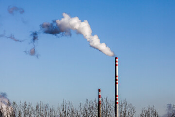Smoking from two factory chimney with blue sky