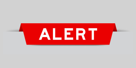 Red color inserted label with word alert on gray background