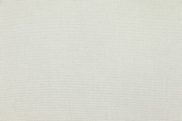 Flat cream-colored fabric texture background. This fabric is made of cotton and polyester.