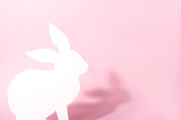 White Easter bunny on pink background. Easter holiday concept with cute handmade bunny