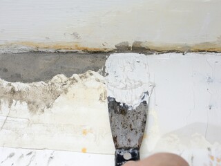 The process of putty of the old aged wall of the house
