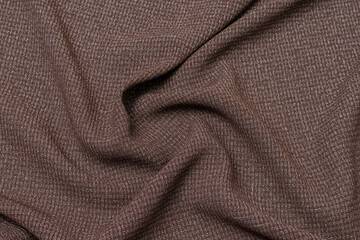 Fototapeta premium Mauled brown-colored fabric texture background. This fabric is made of cotton and polyester.
