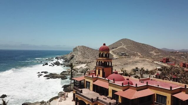 Aerial Tilt Down Revealing Grand Abandoned Red and Yellow Hotel Cerritos Beach Pacific Coast Todos Santos Baja California Sur Mexico Drone 4k