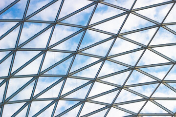 A fragment of a glass dome on the roof of the building. Geometric glass dome. Modern ceiling architecture - Powered by Adobe