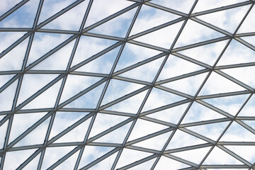 A fragment of a glass dome on the roof of the building. Geometric glass dome. Modern ceiling architecture