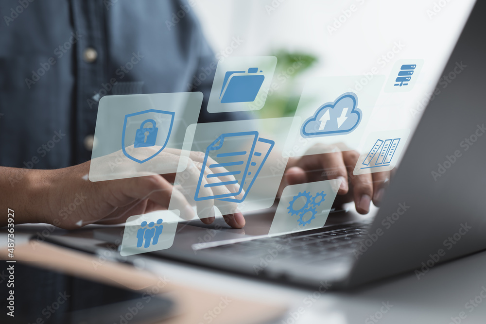 Poster Businessman manages documents on a laptop. Online document database software, as well as a digital file storage system and file access concept. Enterprise resource planning (ERP).