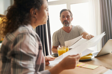 Husband passing document for wife to have a look