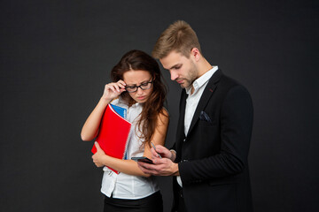 Designed for mobile work. Professional couple using mobile phone. For your business mobility needs