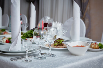 set table in the restaurant with appliances and glasses