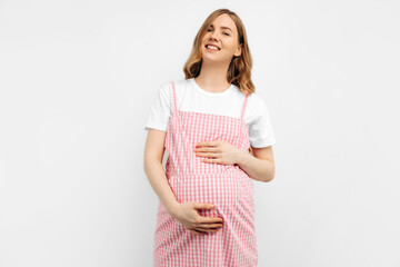 Pregnant happy woman touches her belly. Pregnant mom caressing her belly and smiling close up. Healthy pregnancy concept