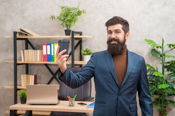 happy mature entrepreneur in jacket having coffee break in paper cup, takeaway