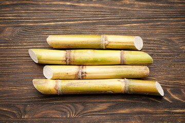 Sugarcane on a wooden background. Top view.