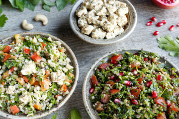 Traditional Tabbouleh salad with parsley and other tabbouleh style salad with barley and feta. Middle Eastern cuisine.