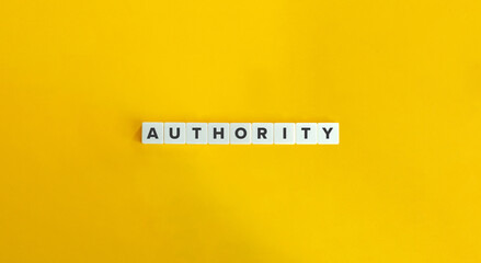 Authority Word on Letter Tiles on Yellow Background. Minimal Aesthetics.