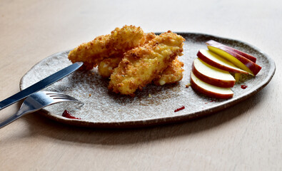 The  cheese sticks with apple slices close up in restaurant
