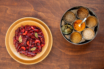 Grated beetroot curry with coconut and cashews with spices in Masala Dabba spice box. Indian...