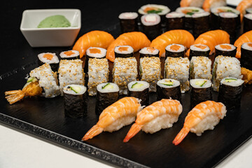 Assorted sushi nigiri and maki big set on slate. A variety of Japanese sushi with tuna, crab, salmon, eel and rolls. Top view
