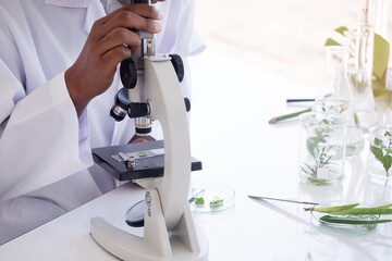 Close-up microscope. Scientist hands with microscope.