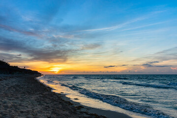 Beautiful sunset on the ocean shore in the evening