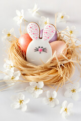 Happy Easter. Сomposition made of Easter cookies and eggs in a nest. Close-up