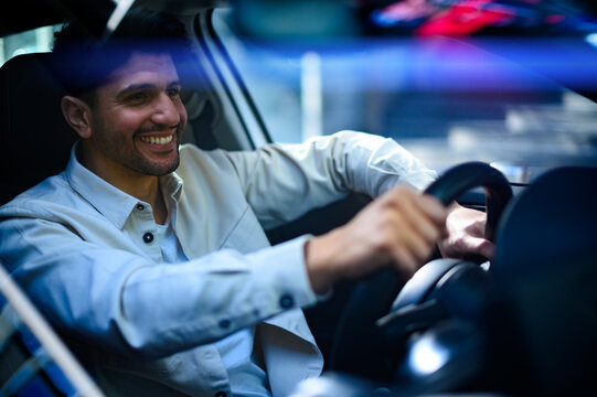 Young Man Driving His Car At Night