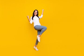 Fototapeta na wymiar Full size photo of young cheerful girl rejoice luck fists hands awesome isolated over yellow color background