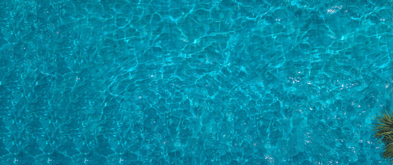 Plakat Swimming pool blue water in summer top view angle. Aerial view images of swimming pool in a sunny day which suitable for sport or relax on vacation time or workout for burn some calories in holiday.