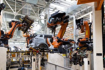 Photo of automobile production line. Modern car assembly plant. Auto industry. Interior of a...