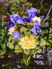 Romantic bouquet with irises, peonies and hydrangea in the garden