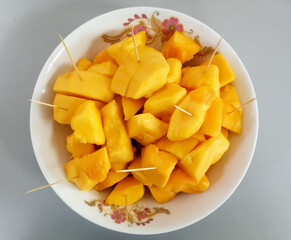 Papaya fruit in dish on white background
