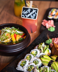 Eating sushi in Asian restaurant. Sushi, soup and homemade lemonades.