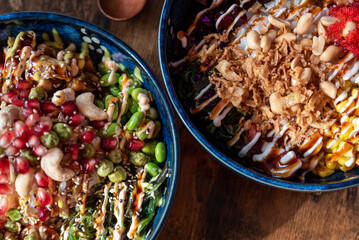 Buddha bowl, healthy and balanced food. Raw Organic Poke Bowl with tofu, chicken and veggies. Top view of Buddha bowl.