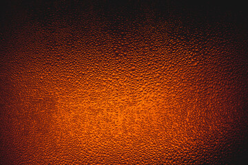 Drops on the glass,Bottle with a cold drink. Thin layer of ice on the glass surface. On a black background