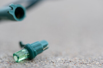 Focus on replacement bulb for a string of Christmas lights to repair a dud. 