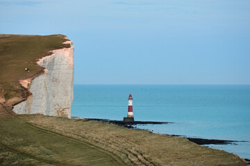 White chalk headland cliffs and Beachy Head Lighthouse. Seven Sisters National park, Eastbourne, East Sussex, England, UK.