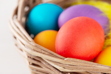 Colored eggs in a basket. Easter concept.