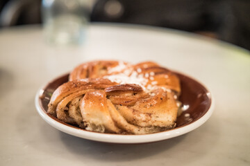 Cinnamon Roll, A Swedish Kanelbulle With Pearl Sugar. - close up