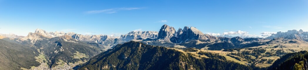 Fototapeta na wymiar Super panorama of Langkofel Group mountains and valleys below. Seiser Alm, South Tyrol, Italy.