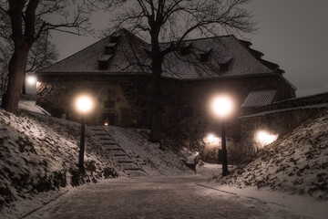 Oslo, Norway - December. Inside the walls of the Akershus Fortress on a cold gloomy snowy winter night.