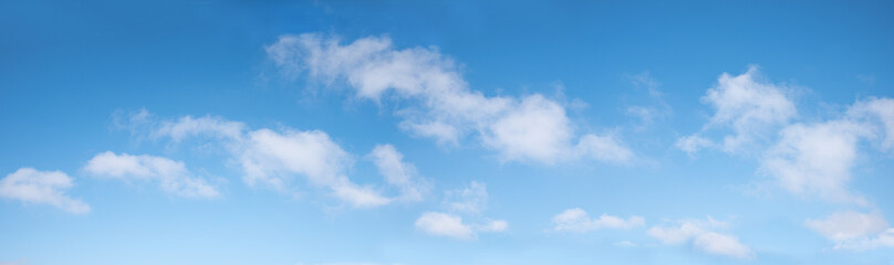 gradient blue sky panorama with soft cumulus clouds