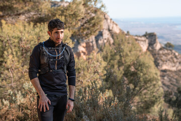 Portrait of a young trail runner in the mountains.