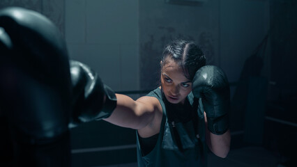 Portrait Shot of an Ethnic Badass Female Boxer Training With Her Coach, Hitting Her While Protecting Her Head. Training Together at an Old and Beat Down Boxing Studio Gym. Confident Woman Athlete.