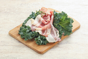 Raw pork bacon over board